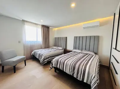 Cama o camas de una habitación en Elegante con vista al mar y malecón by G P S rentas