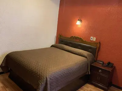 Cama o camas de una habitación en Hotel Los Arcos