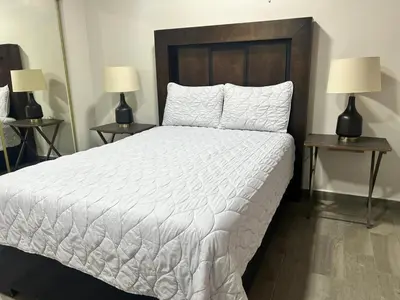 Cama o camas de una habitación en HOTEL and Suites Cananea