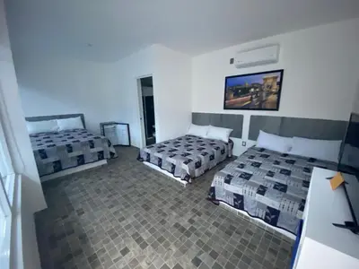 Cama o camas de una habitación en Blue Inn Hotel & Suites