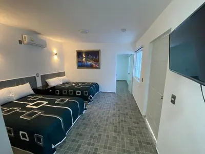 Cama o camas de una habitación en Blue Inn Hotel & Suites