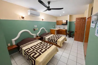 Cama o camas de una habitación en Blue Pacific Suites