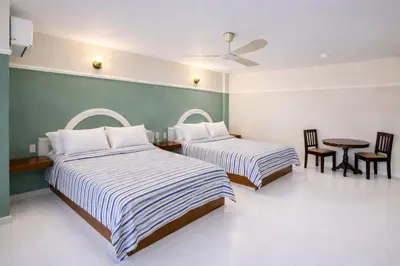 Cama o camas de una habitación en Blue Pacific Suites
