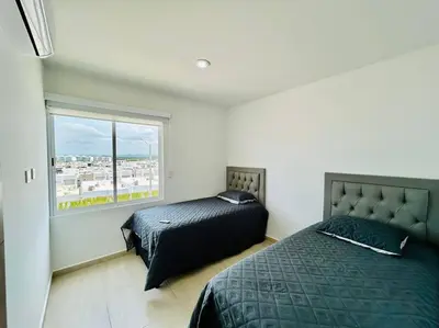 Cama o camas de una habitación en cómodo con alberca cerca de la playa by G P S rentas