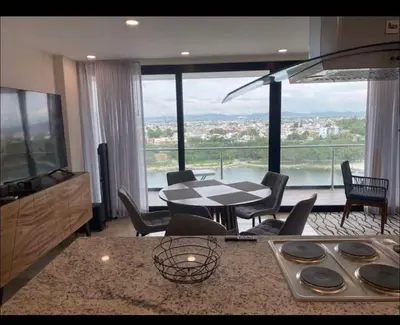 Zona de estar de Departamento a pie de playa con alberca infinty en piso 22