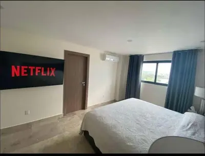 Cama o camas de una habitación en Departamento a pie de playa con alberca infinty en piso 22