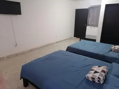 Cama o camas de una habitación en Torre Romo Departamento 1-3