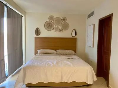 Cama o camas de una habitación en Hermoso condominio frente al mar