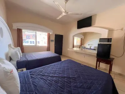 Cama o camas de una habitación en Hotel Oasis