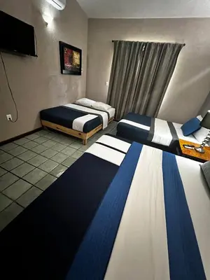 Cama o camas de una habitación en Casa Lomas en Zona Dorada, 5 minutos de la playa