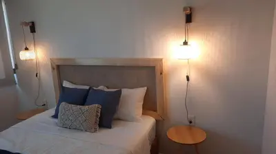 Cama o camas de una habitación en Mazablue depa en laguna con playas artificiales