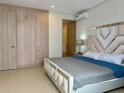 Cama o camas de una habitación en Departamento moderno a pie de playa