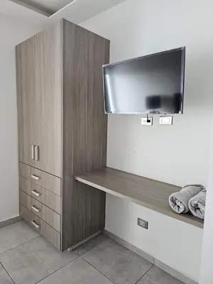 Una televisión o centro de entretenimiento en Departamento estilo Hotel