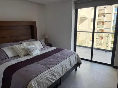 Cama o camas de una habitación en Departamento con alberca en Mazatlán