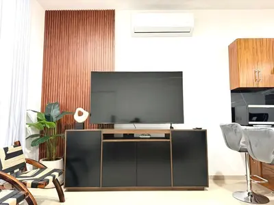 Una televisión o centro de entretenimiento en Encanto de Playa Sur By GEstores