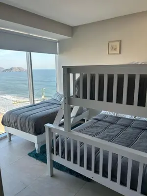 Cama o camas de una habitación en Beachfront Apartment
