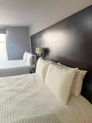 Cama o camas de una habitación en Nueva Vizcaya & Suites