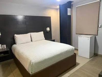 Cama o camas de una habitación en Nueva Vizcaya & Suites