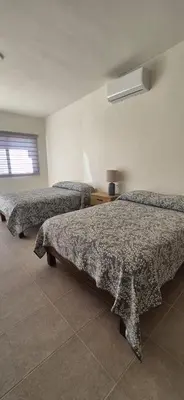 Cama o camas de una habitación en Suites EL FARO San Carlos