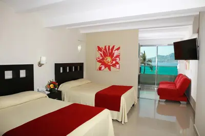 Cama o camas de una habitación en Las Flores Beach Resort