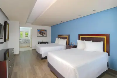 Cama o camas de una habitación en Quinta Dorada Hotel & Suites