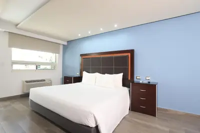 Cama o camas de una habitación en Quinta Dorada Hotel & Suites