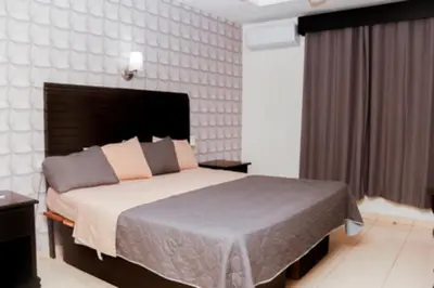 Cama o camas de una habitación en Maxihotel Business Class Culiacan