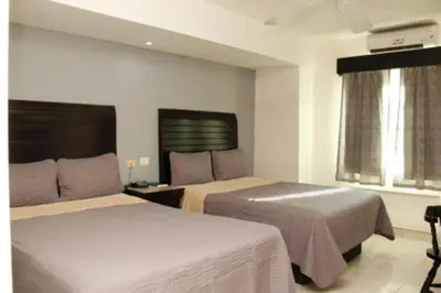 Cama o camas de una habitación en Maxihotel Business Class Culiacan