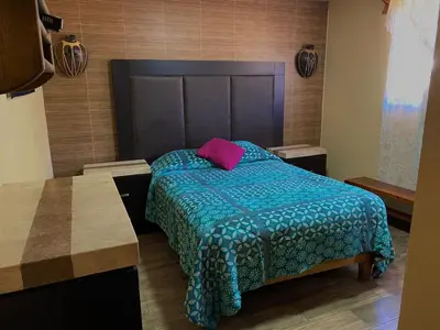 Cama o camas de una habitación en TARAMURI HOTEL & TOURS