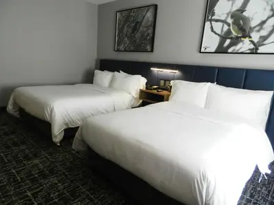 Cama o camas de una habitación en voco Saltillo Suites by IHG